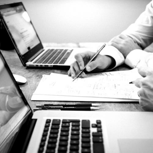 two people at laptops