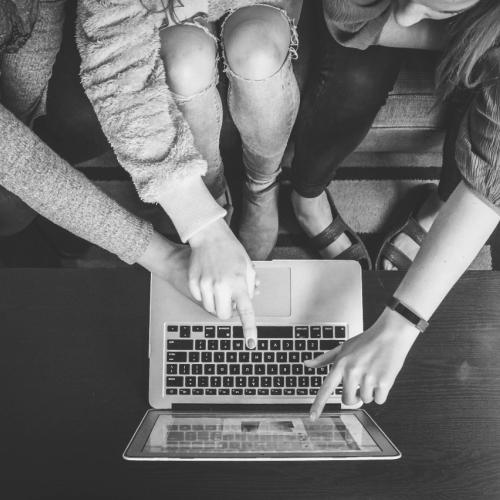 People collaborating on one laptop